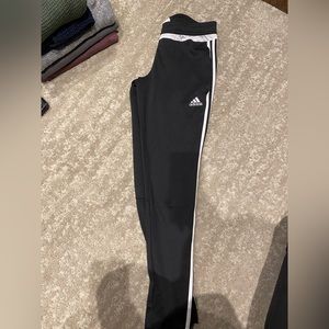 Women’s medium adidas pants with zipper slit at ankle.